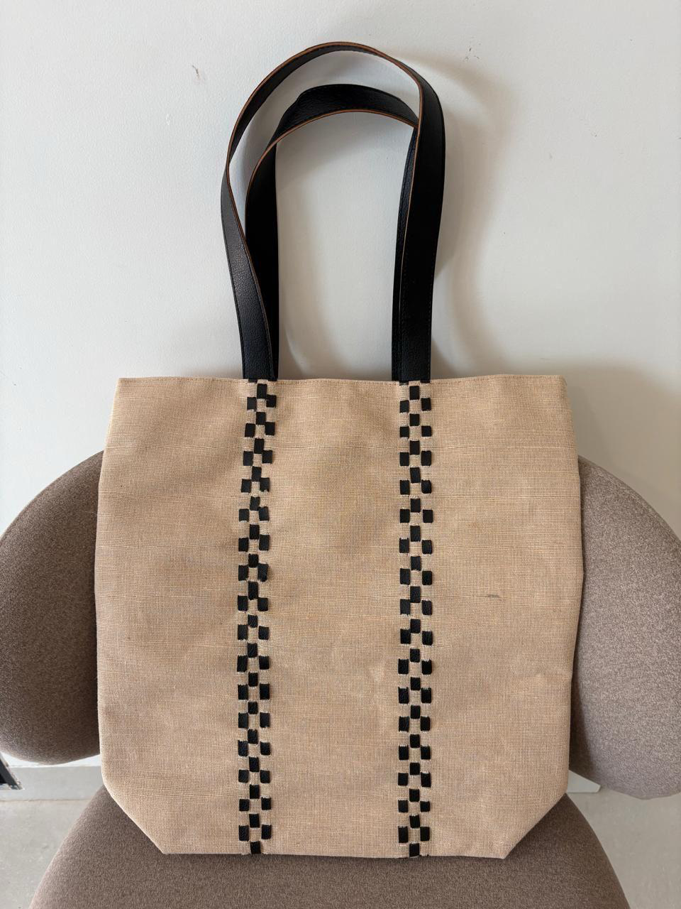 Olivia jute-cotton tote with black woven detailing and long black straps.