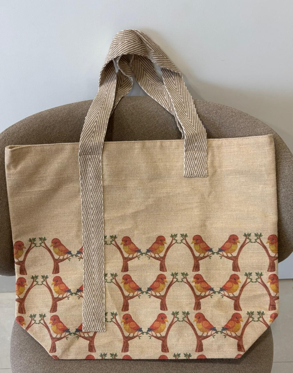 Veronica jute-cotton bag in a repeating rust bird print.