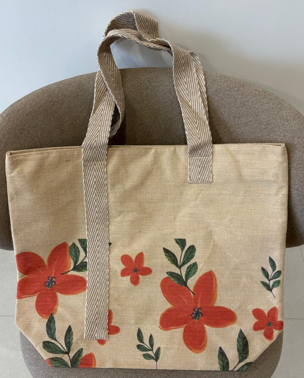 Veronica jute-cotton bag in a rust floral and green leaf print.