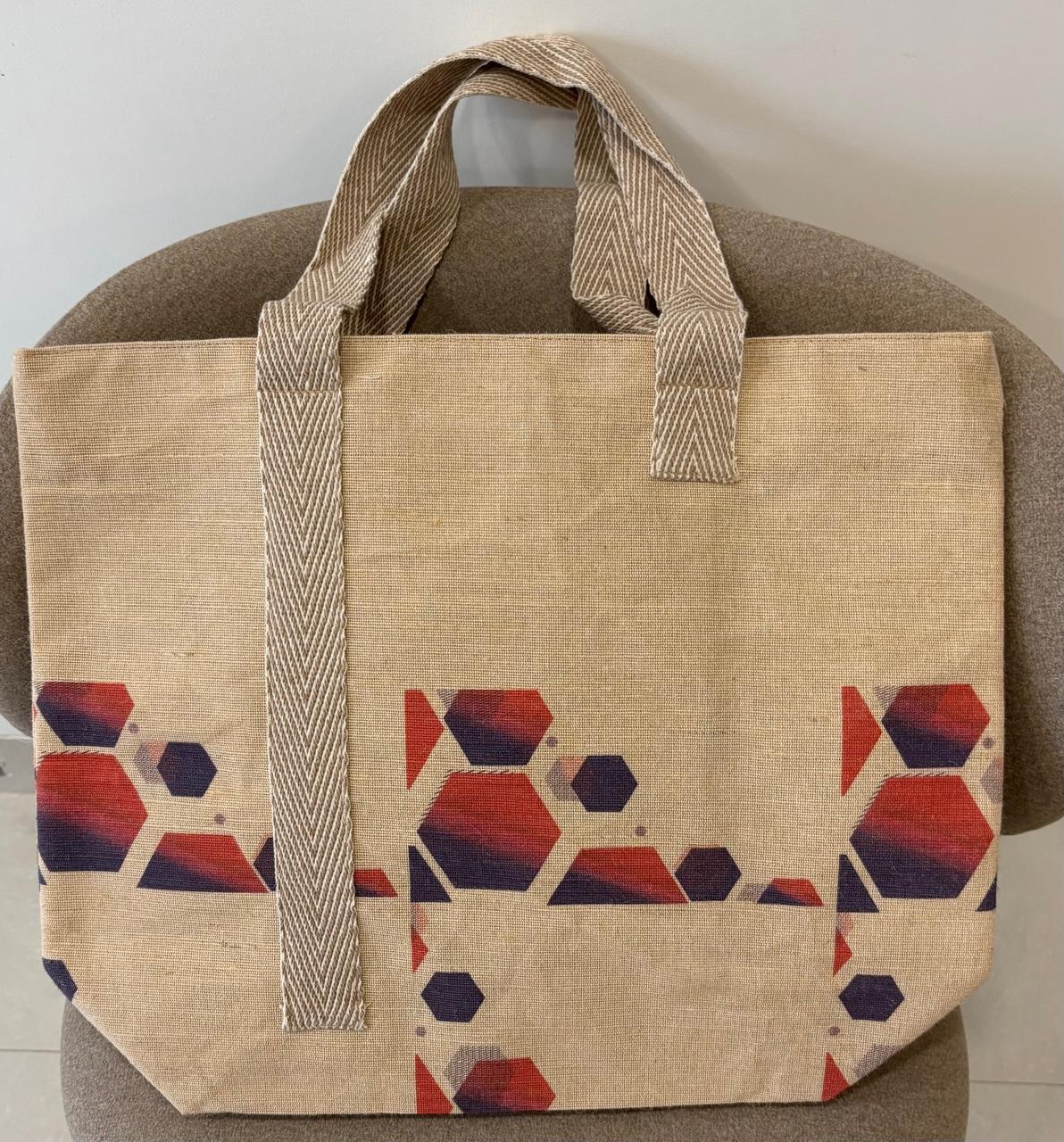 Veronica jute-cotton bag in a rust and navy hexagon print.